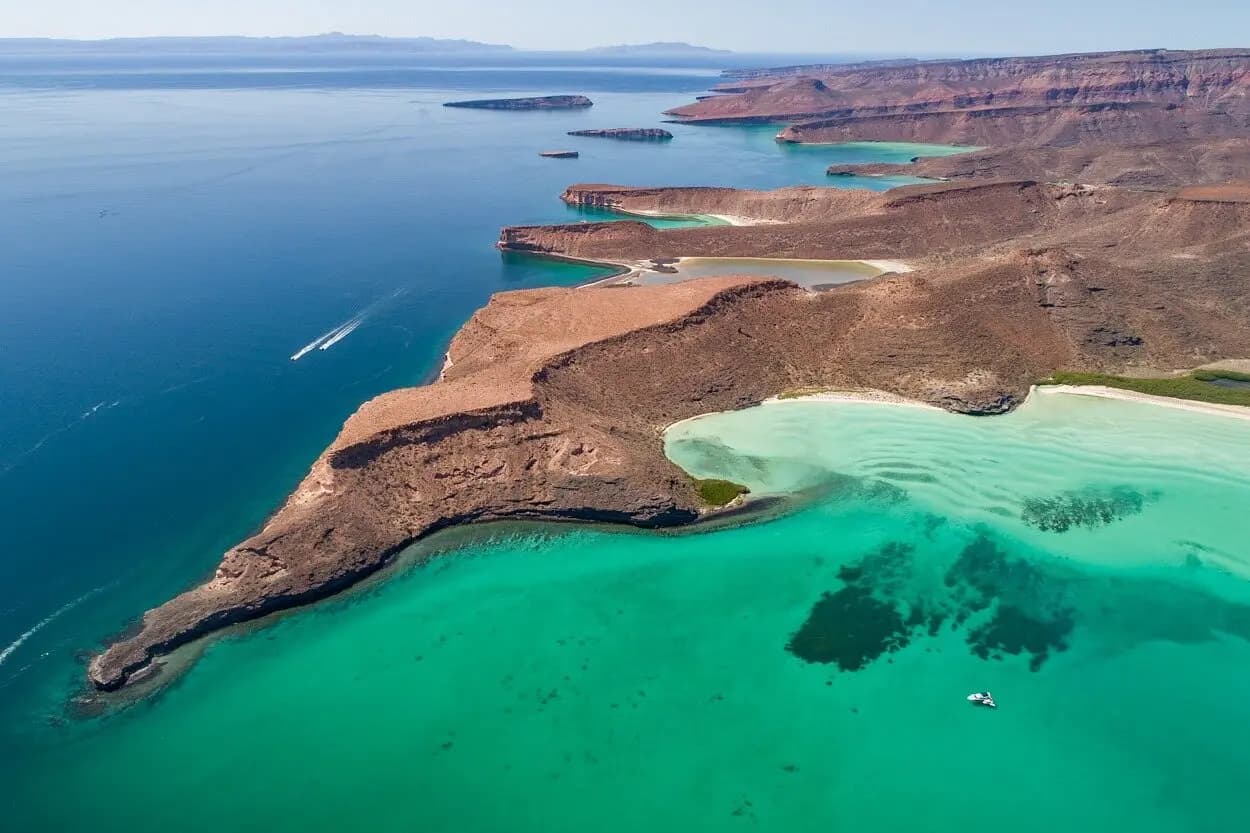 Aerial view of red desert headlands and turquoise bays on Espíritu Santo Island