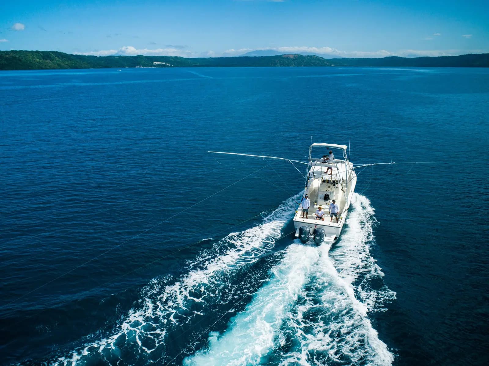 Aerial view of a sportfishing boat speeding across deep blue water off the Guanacaste coast