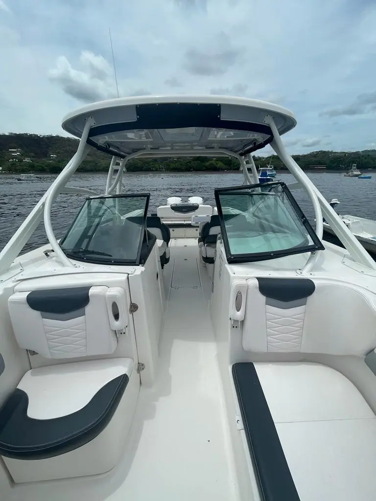 View aft from the bow of the dual console boat through the open windshield to the hardtop and helm
