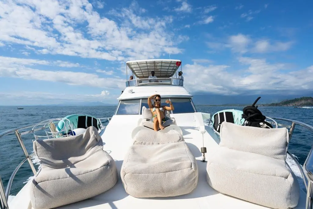 Woman relaxing in a bean bag lounger on a motor yacht's foredeck off the Costa Rica coast
