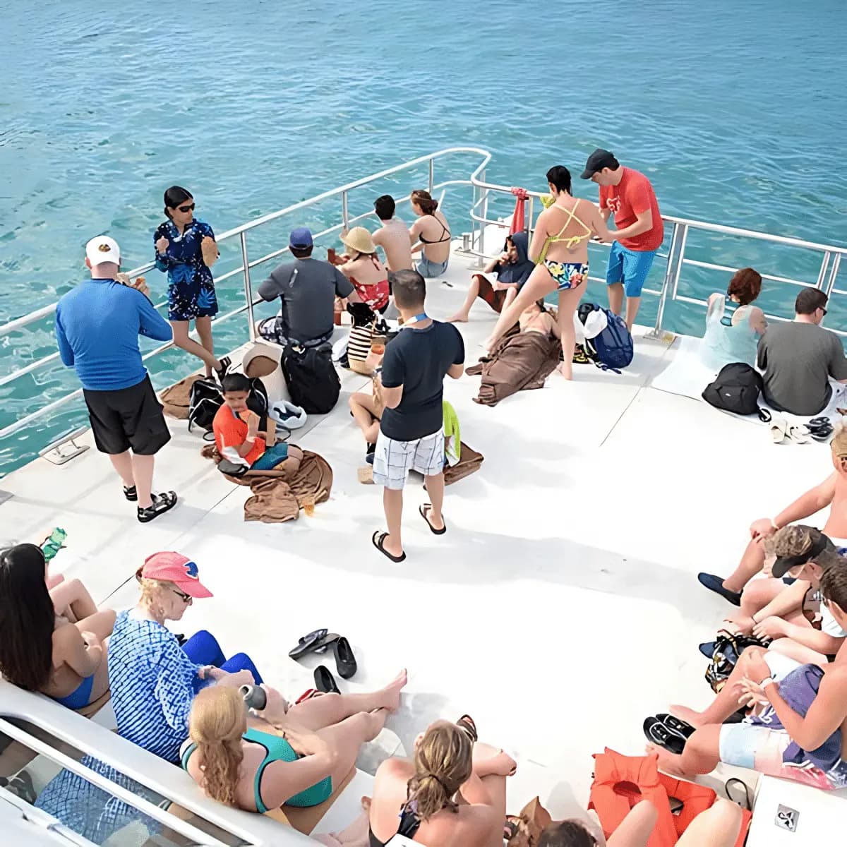 Guests relaxing on the open front deck of a catamaran out on the water off Ocho Rios