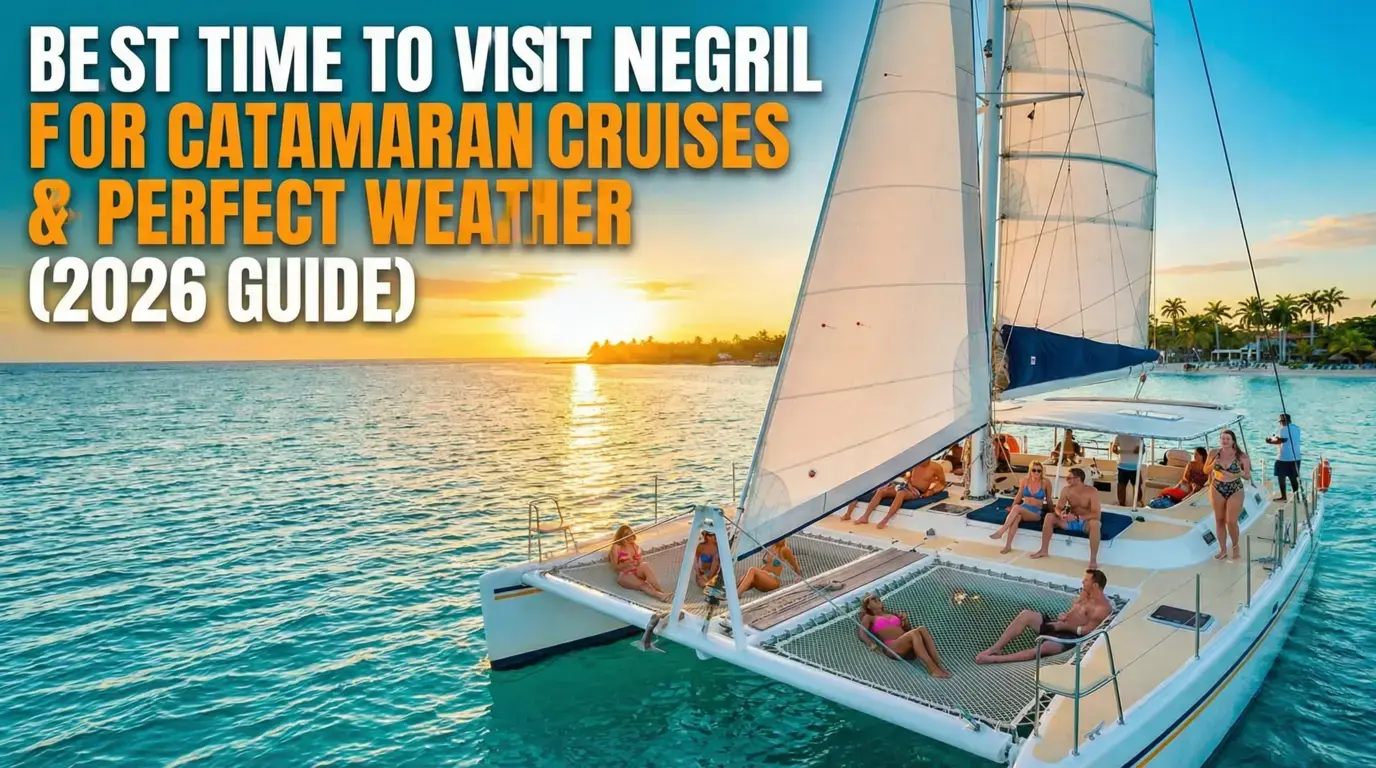 Guests lounging on the nets of a catamaran under sail at sunset off Negril's palm-lined shore