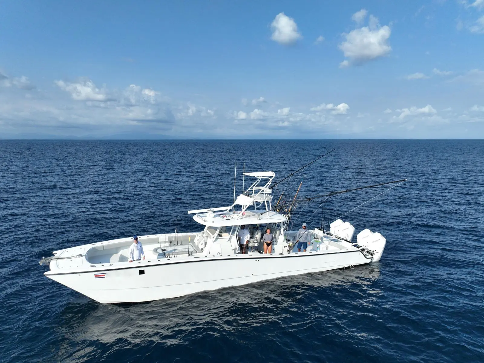 Large center console sportfishing boat drifting on open blue water off Costa Rica with guests on deck