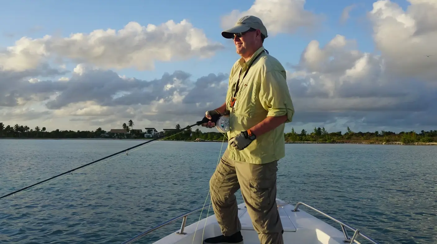 Angler in a sun shirt fishing from the bow over calm inshore water off Punta Cana