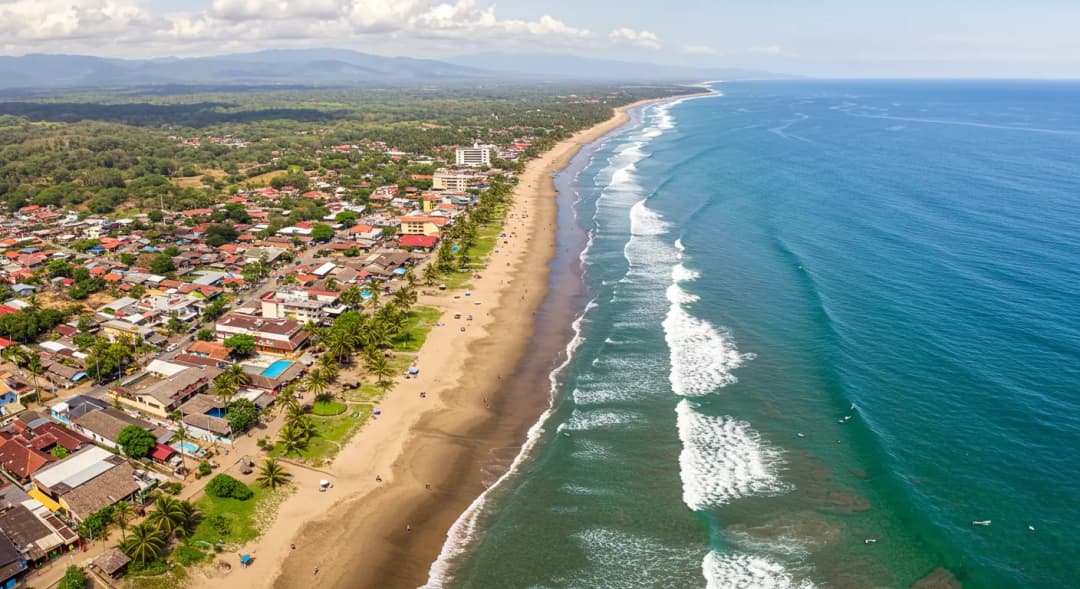 Best Places to Visit in Costa Rica, featuring an aerial view of a vibrant beach town along the coastline with rolling waves.