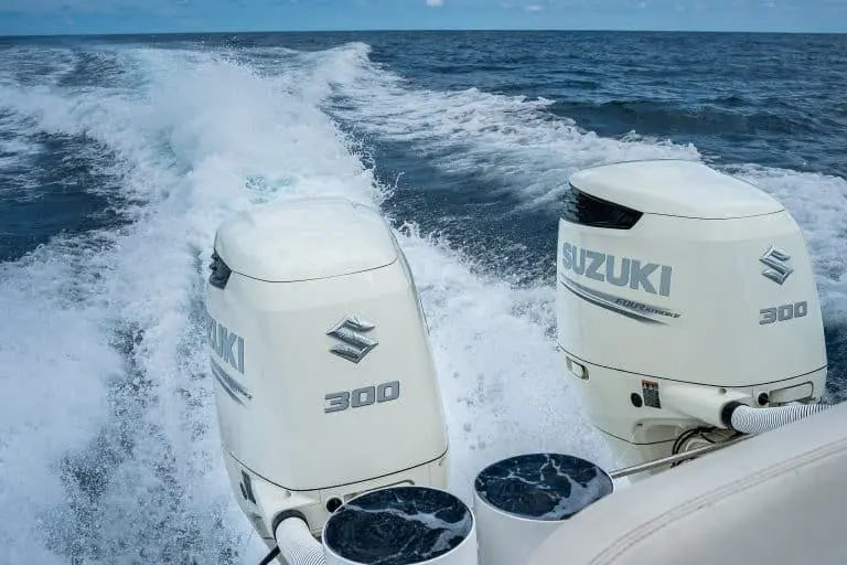 Twin outboard engines kicking up a foaming wake behind a center console boat off Costa Rica