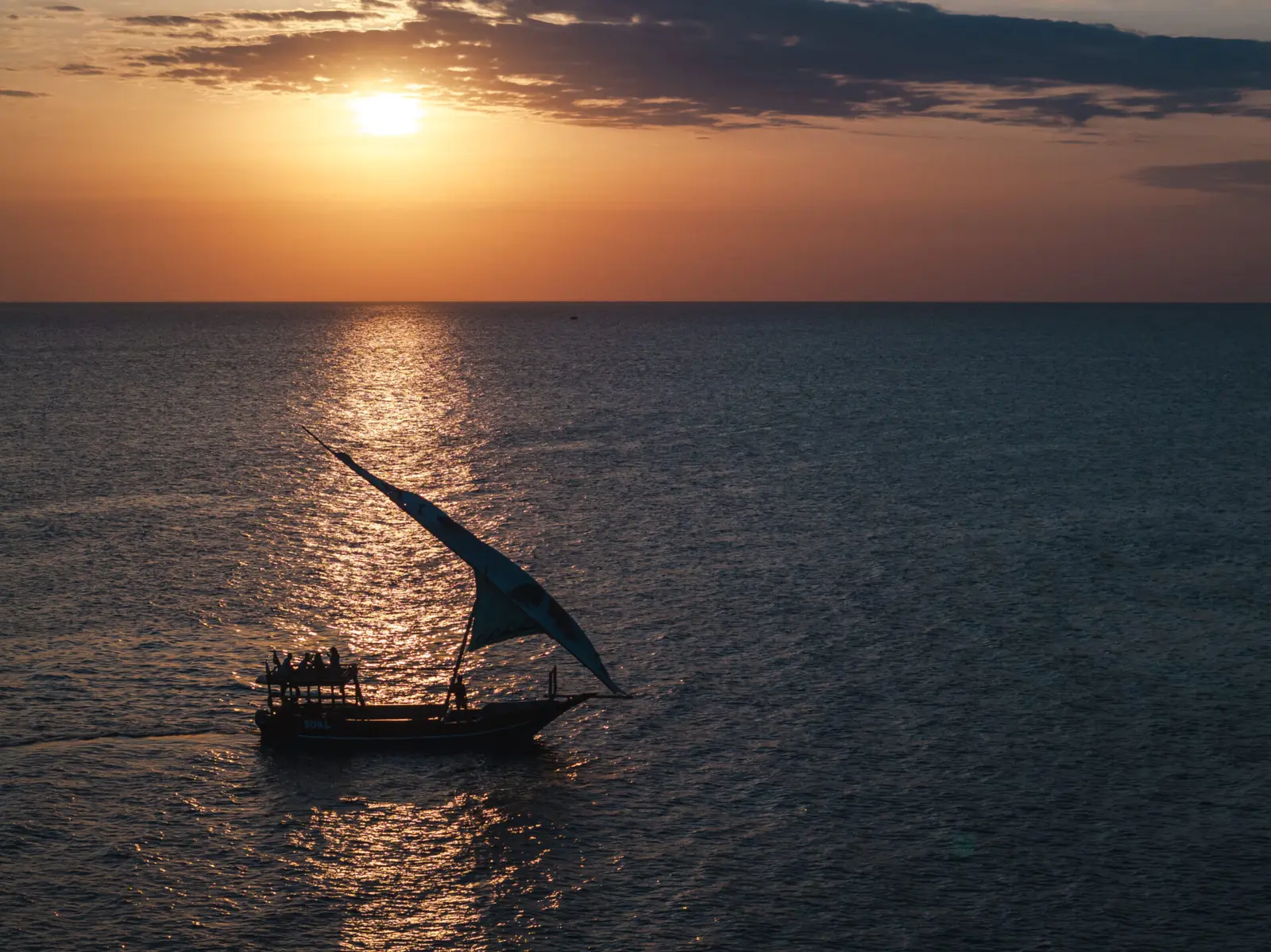 Traditional dhow under sail at sunset off Kendwa and Nungwi, Zanzibar