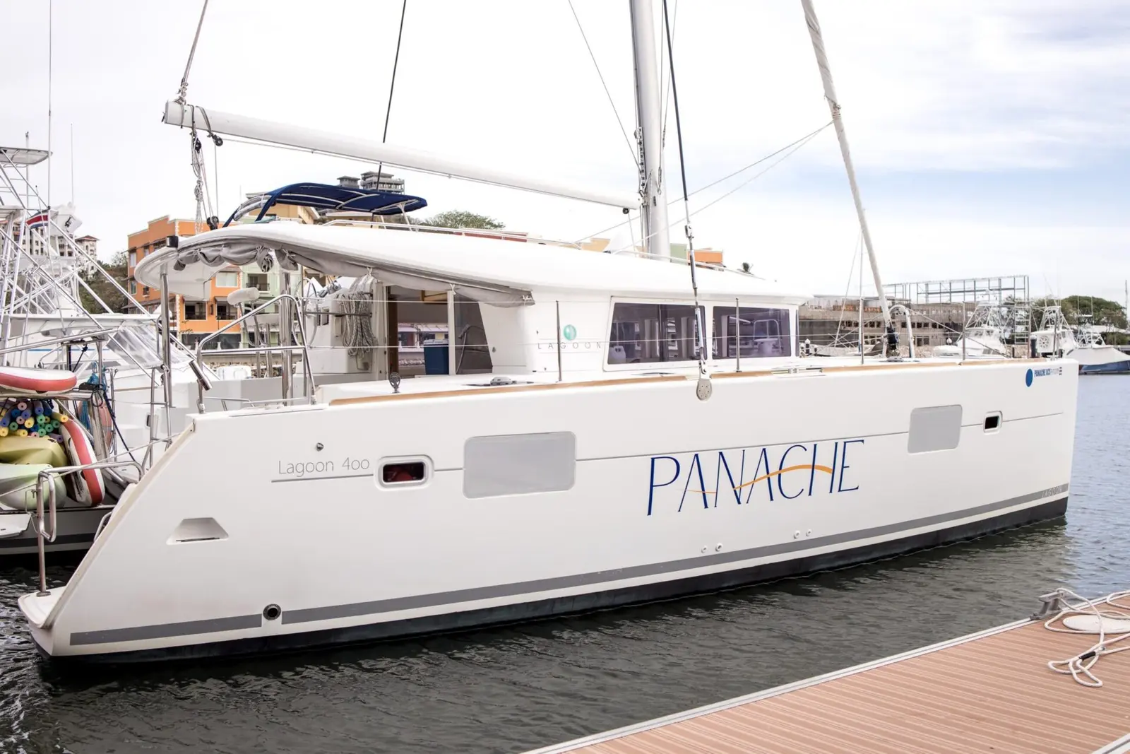 White sailing catamaran tied up at a floating marina dock in Costa Rica