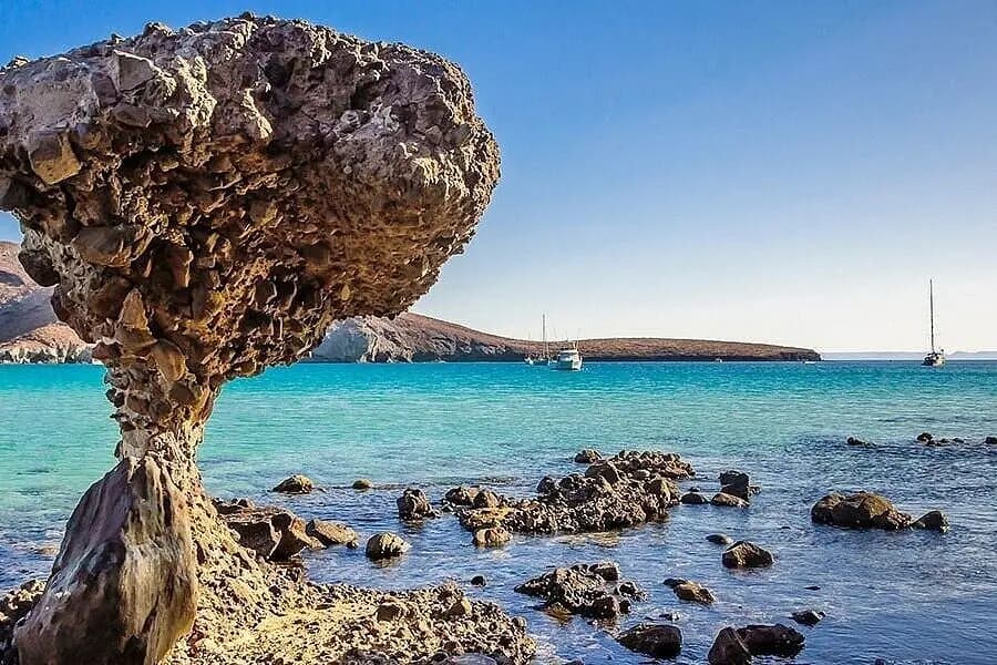 Close view of the mushroom-shaped rock at Balandra Bay with sailboats anchored beyond