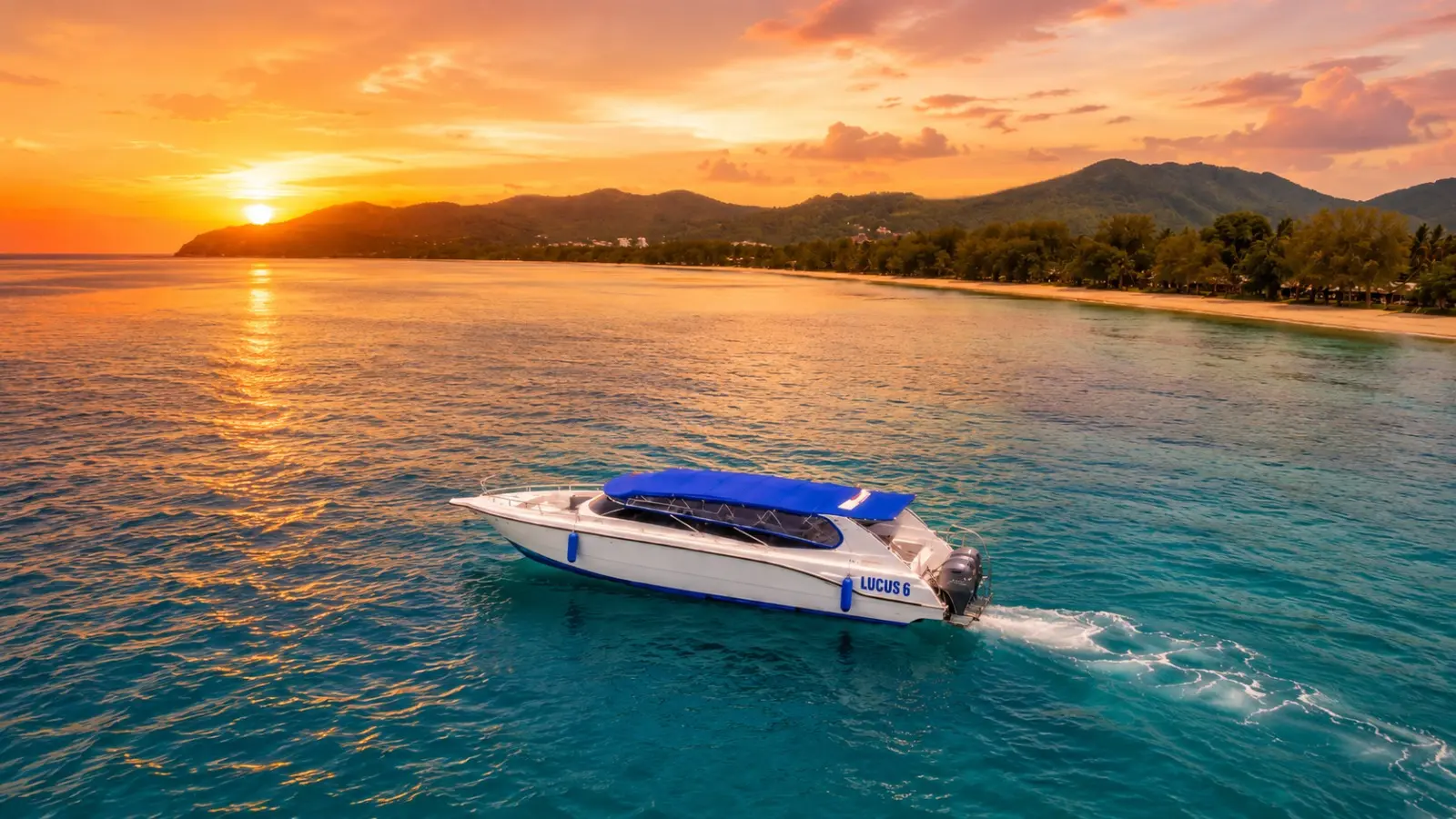 Speedboat with a blue canopy cruising calm water at sunset off a hilly Phang Nga Bay shore