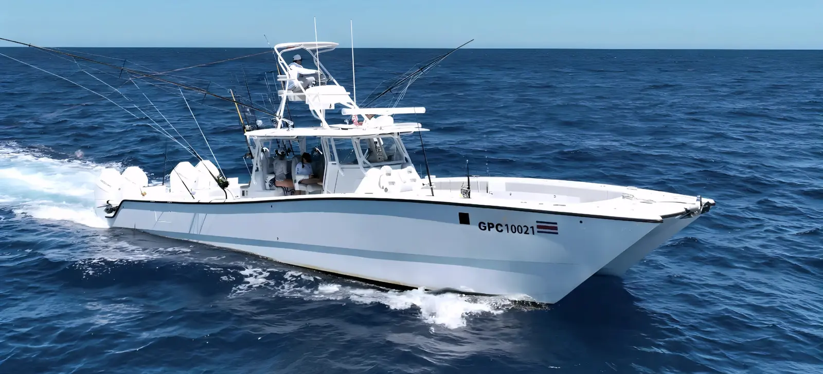 Sportfishing boat running fast across the deep blue sea off Costa Rica with its outriggers raised
