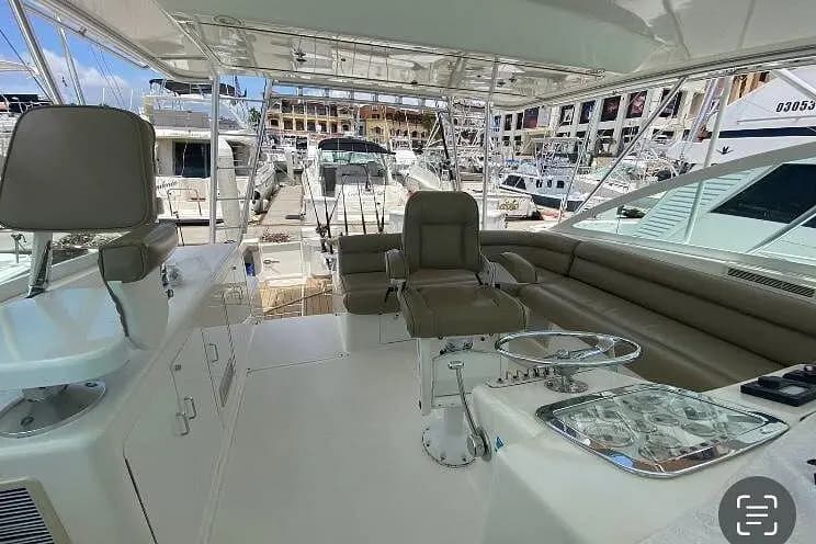 The yacht's covered helm with two captain's chairs and a bench overlooking the Cabo San Lucas marina