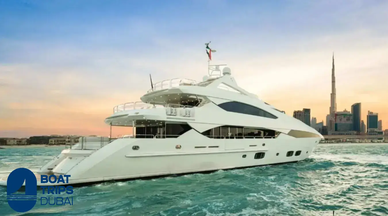 Superyacht cruising at sunset past the Dubai skyline and the Burj Khalifa
