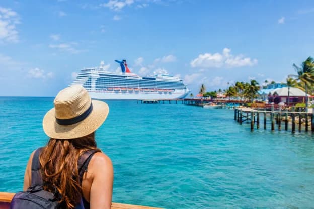 Tourist overlooking a cruise ship and turquoise Caribbean waters near the Belize coast