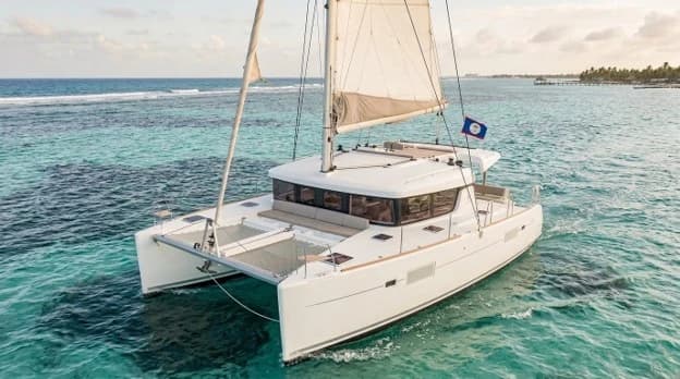 Catamaran sailing on turquoise Caribbean waters near Ambergris Caye, Belize.