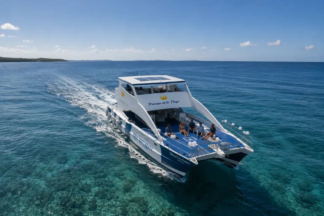Cruise-friendly catamaran tour from Puerto Plata sailing over clear turquoise water with guests relaxing on deck