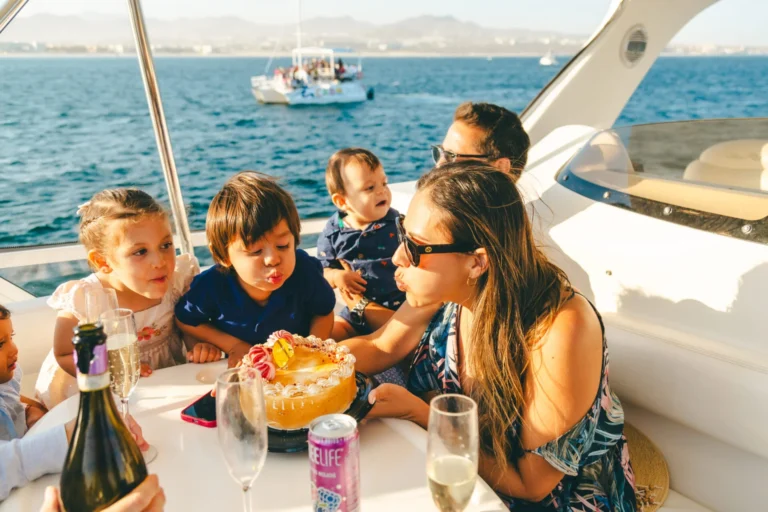Family enjoying a Cabo Food Tour on a boat with local food, drinks, and ocean views.