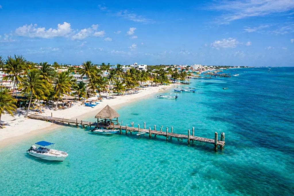 Isla Mujeres beach with turquoise water and pier showing one of the top places to visit in Cancun