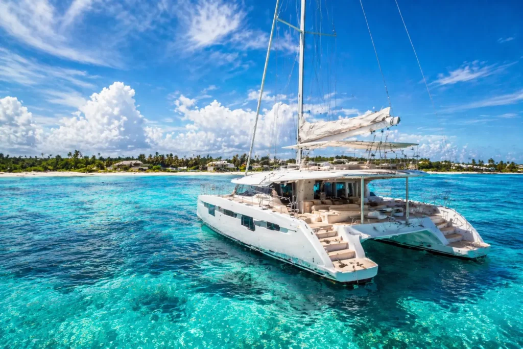 Best catamaran tours Cancun with a luxury catamaran on clear turquoise water near tropical coast