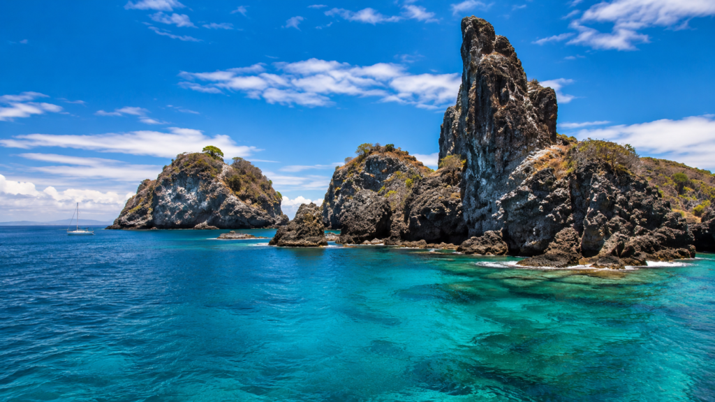 Volcanic rock pinnacles of the Catalina Islands in Costa Rica rising from clear turquoise Pacific water, a popular diving and snorkeling destination.