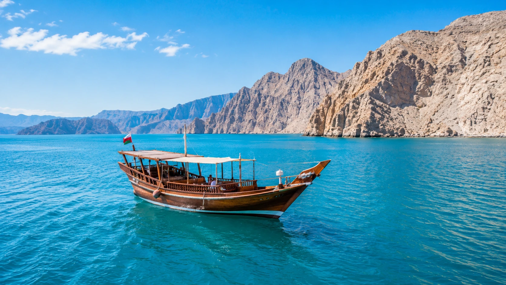 Omani dhow cruise in Musandam fjords during peak boat season