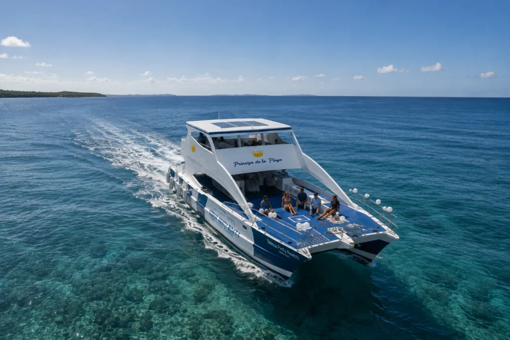 Cruise-friendly catamaran tour from Puerto Plata sailing over clear turquoise water with guests relaxing on deck