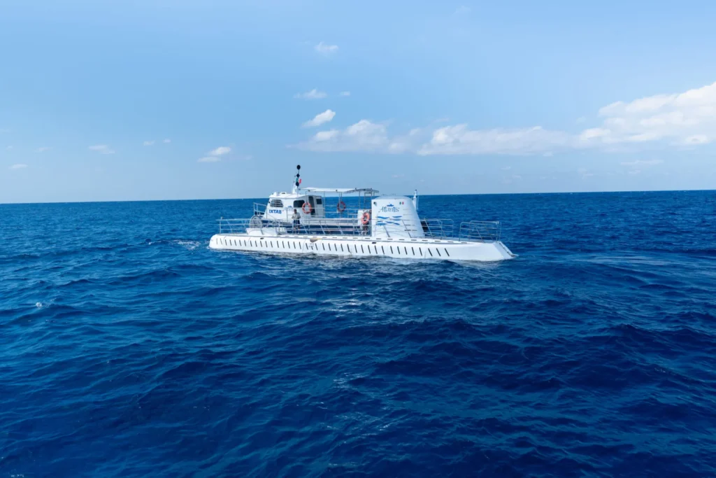 Atlantis submarine tour vessel cruising through deep blue waters off the coast of Cozumel.