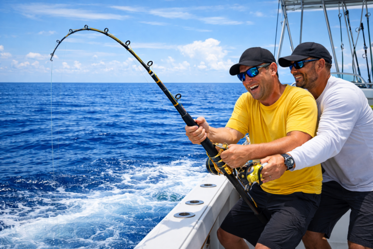 Cap Cana Fishing Season with two anglers fishing from a boat on deep blue ocean waters under a sunny sky.