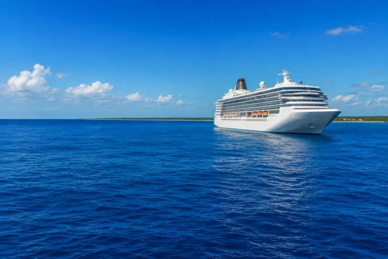 Tours in Cozumel for Cruisers with a cruise ship sailing through deep blue Caribbean waters near Cozumel.