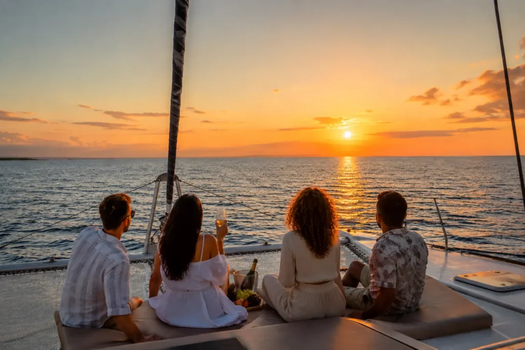 Private Cozumel catamaran charter cruise with a small group enjoying a sunset over the Caribbean Sea.