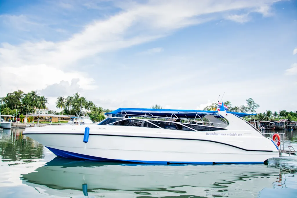 White speedboat docked in tropical waters, representing a private boat tour in Thailand from Phuket.