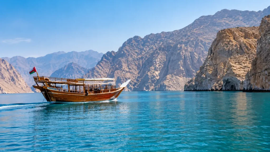 Traditional Dhow Beneath Rugged Mountains