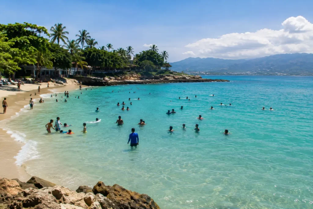 Sunny Tropical Beach Cove with Swimmers and Mountains